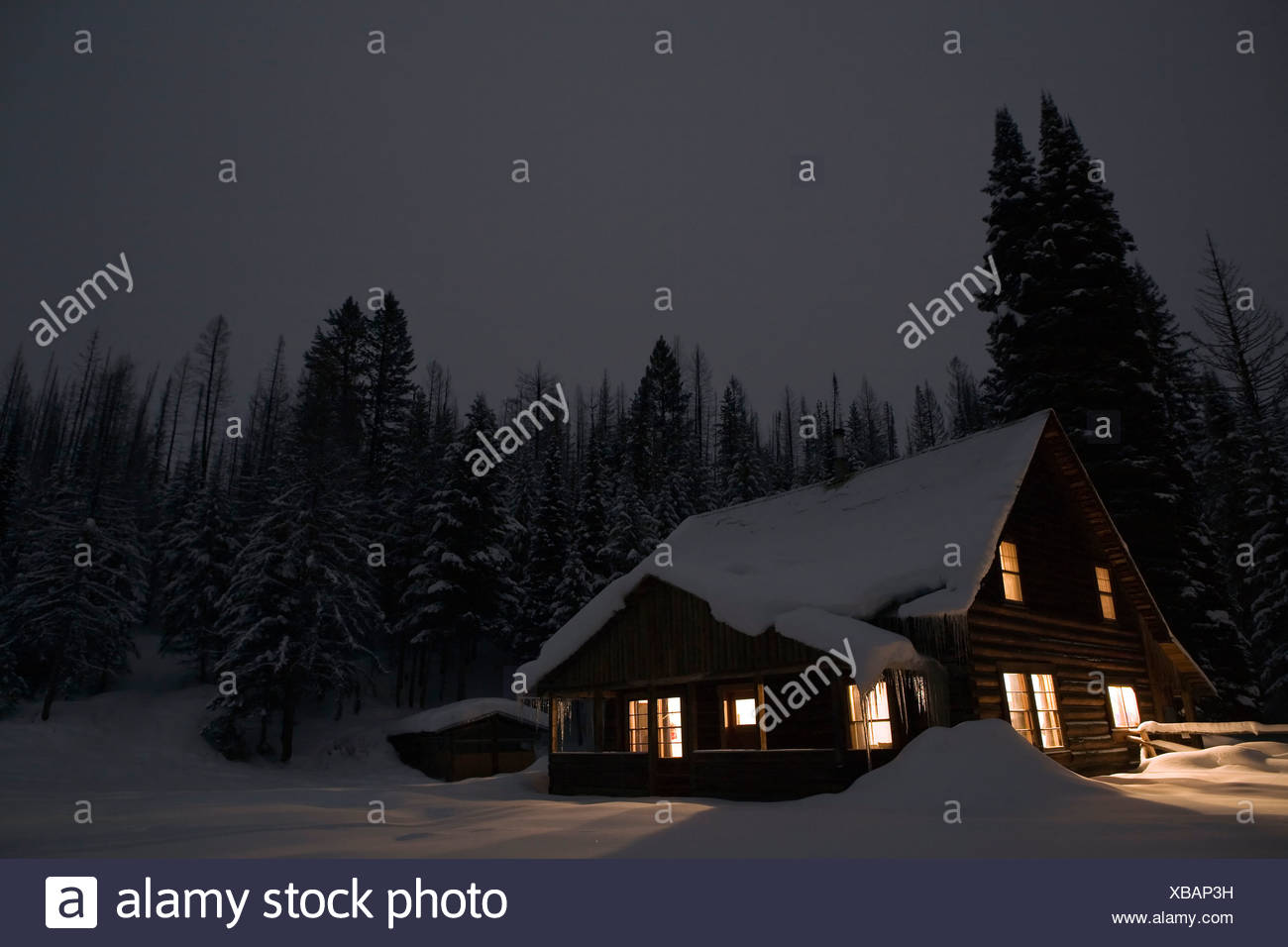 Forest Service Cabin Glowing During Winter Night Polebridge