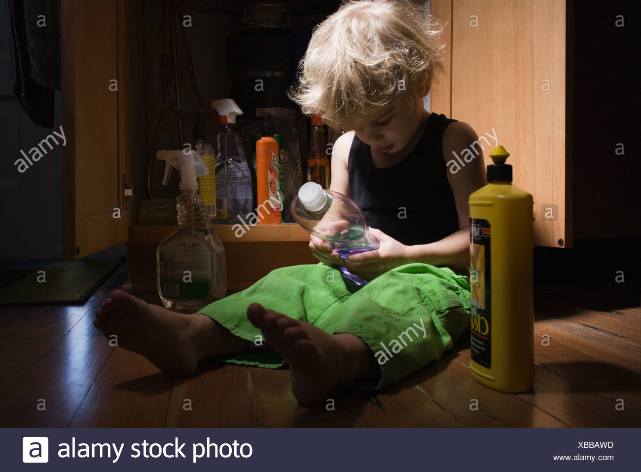 Little boy with cleaning products Stock Photo