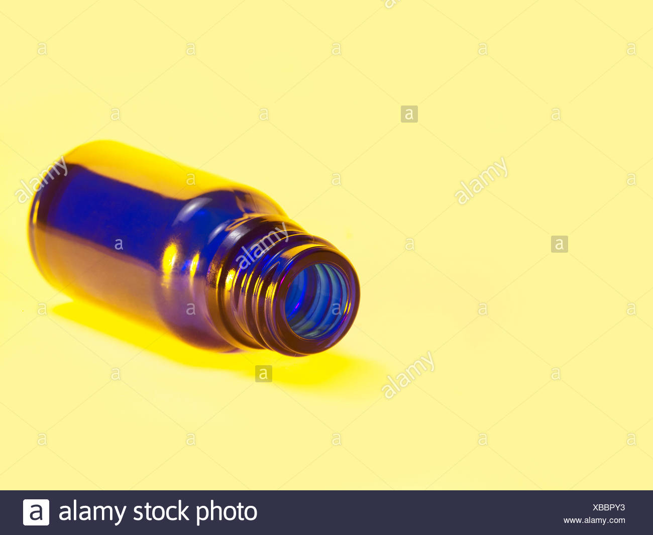 Download Small Blue Bottle In Light Yellow Back Stock Photo Alamy Yellowimages Mockups