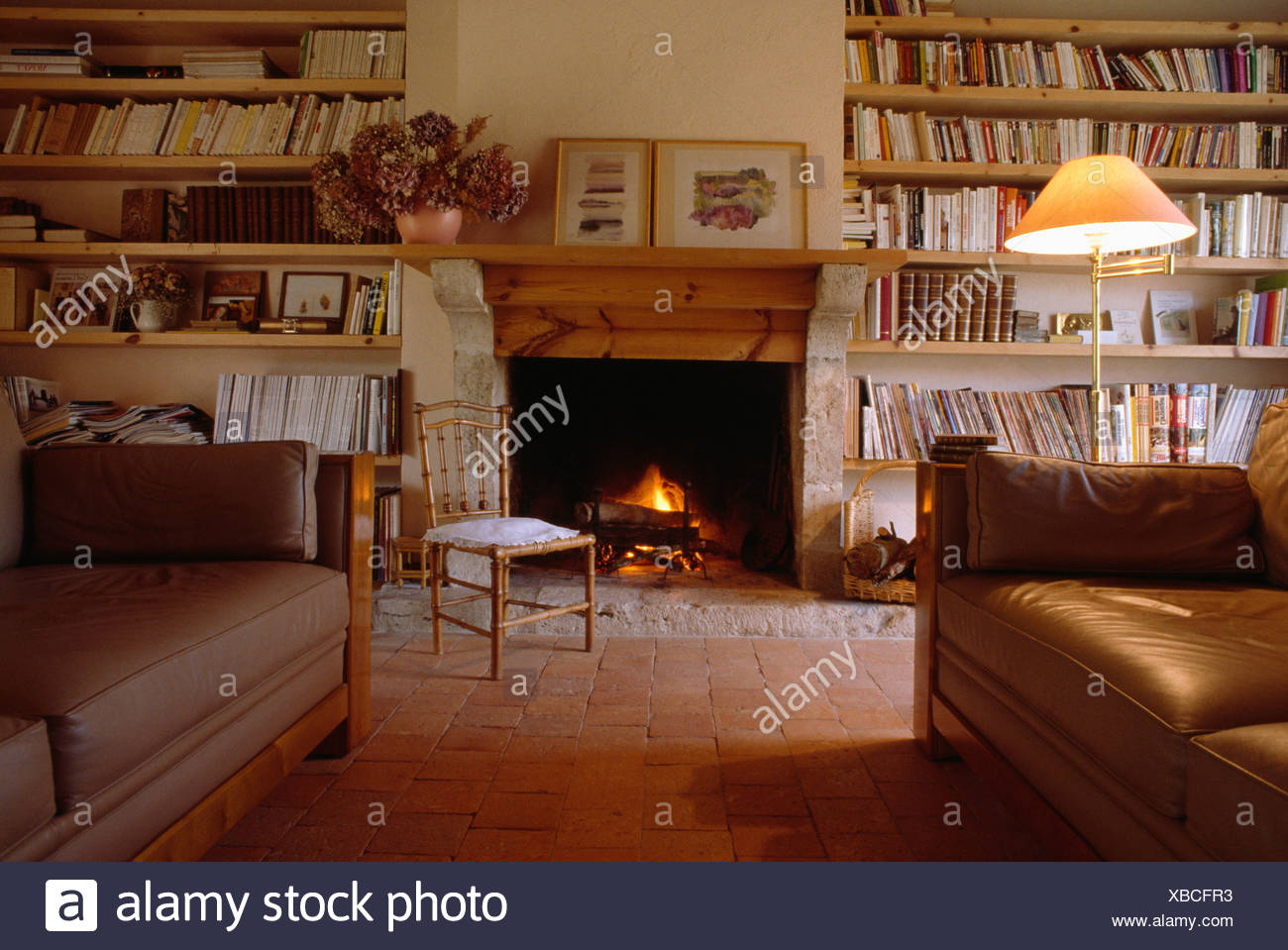 Bookshelves On Either Side Of Fireplace In Country Sittingroom