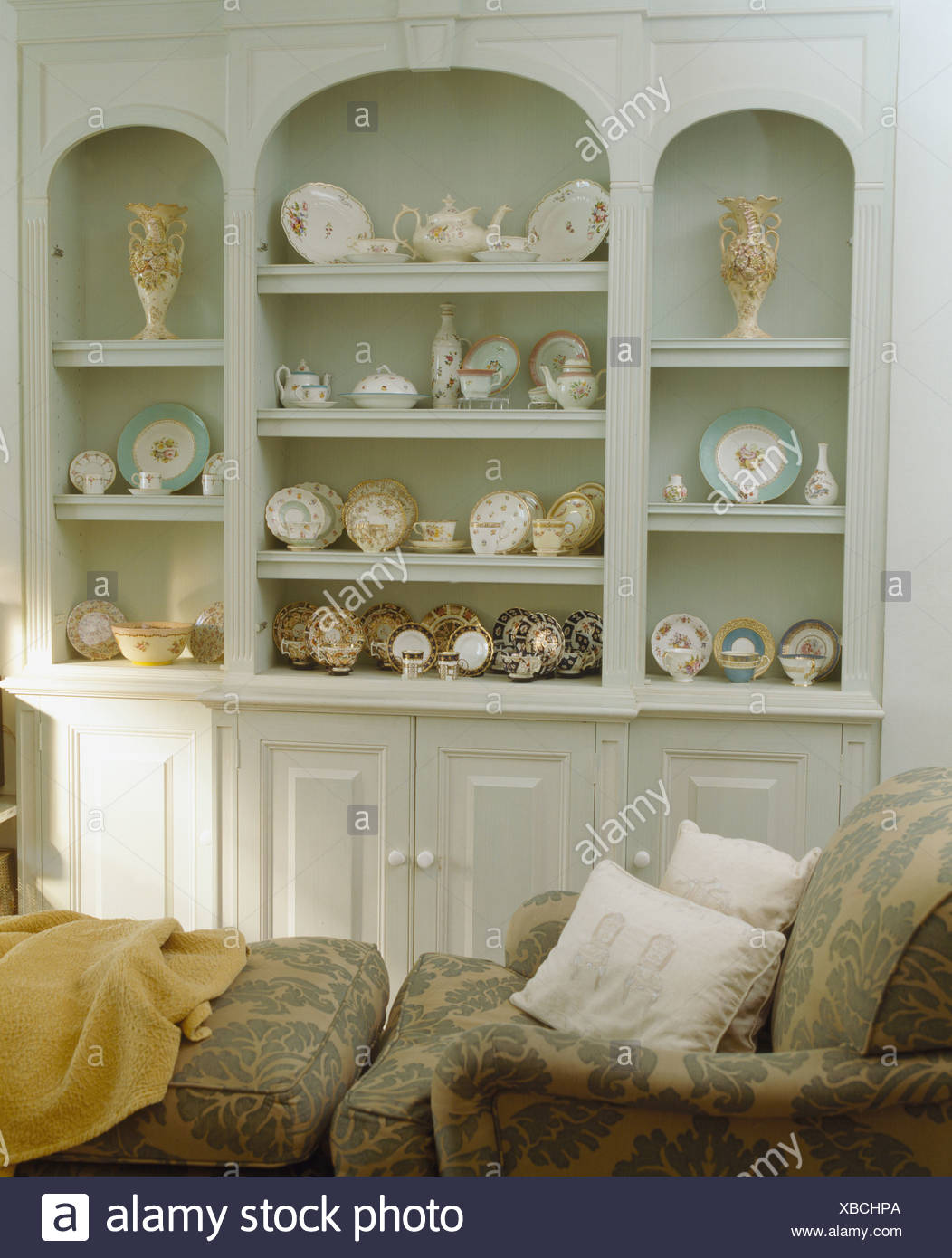 Collection Of Antique China On Alcove Shelving In Pale Gray Fitted