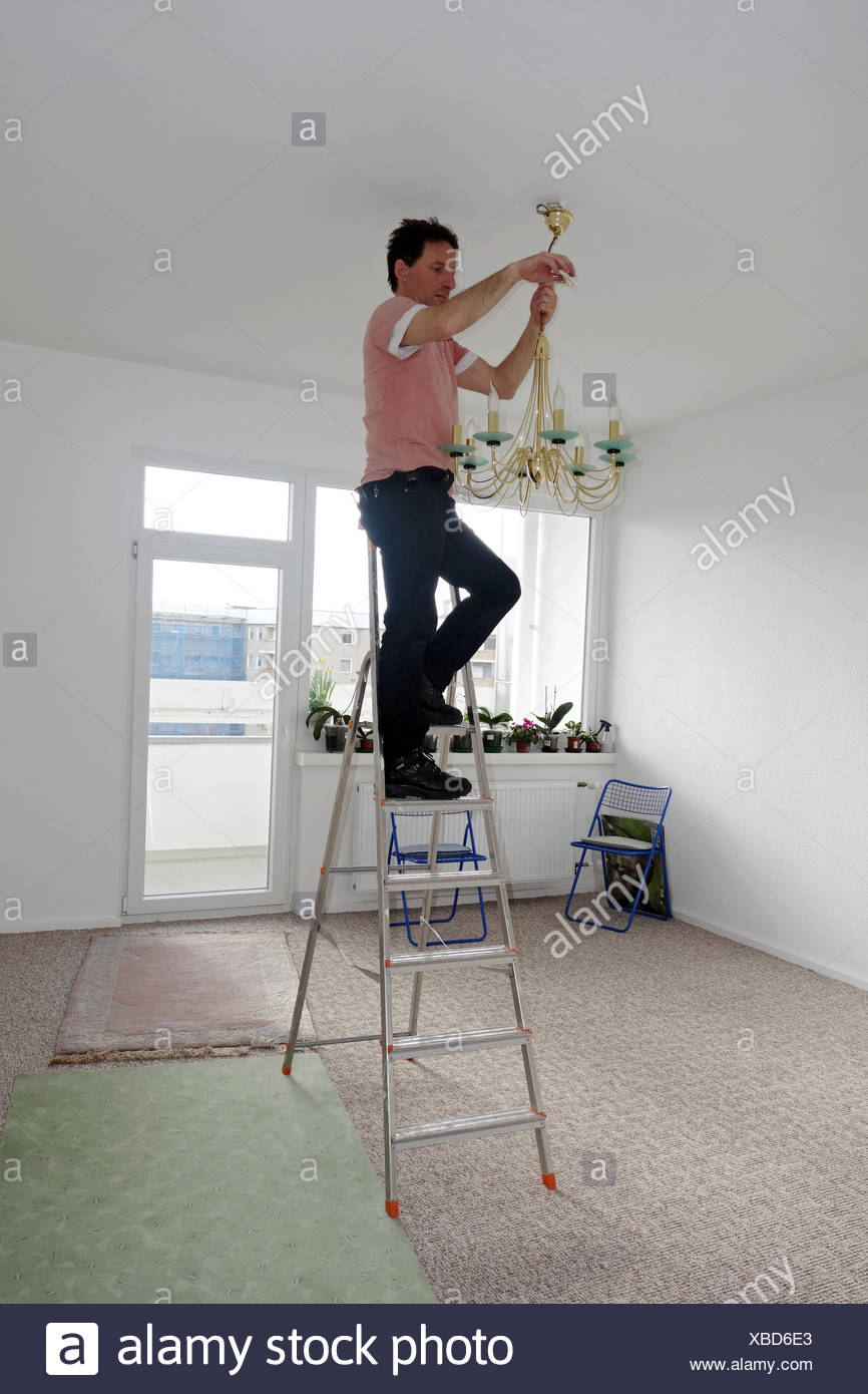 Berlin Germany Man Mounted A Chandelier On The Ceiling Stock