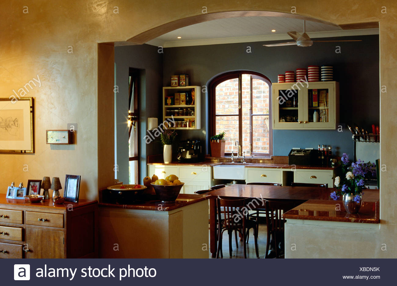 View Through Arch Of Kitchen Dark Blue And Dark Yellow Walls