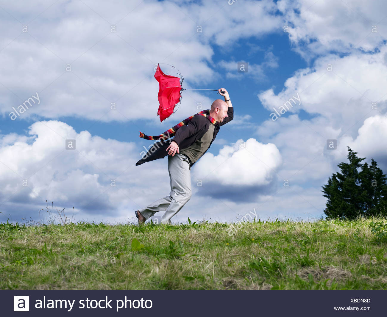 People Leaning Into The Wind Stock Photos & People Leaning Into The