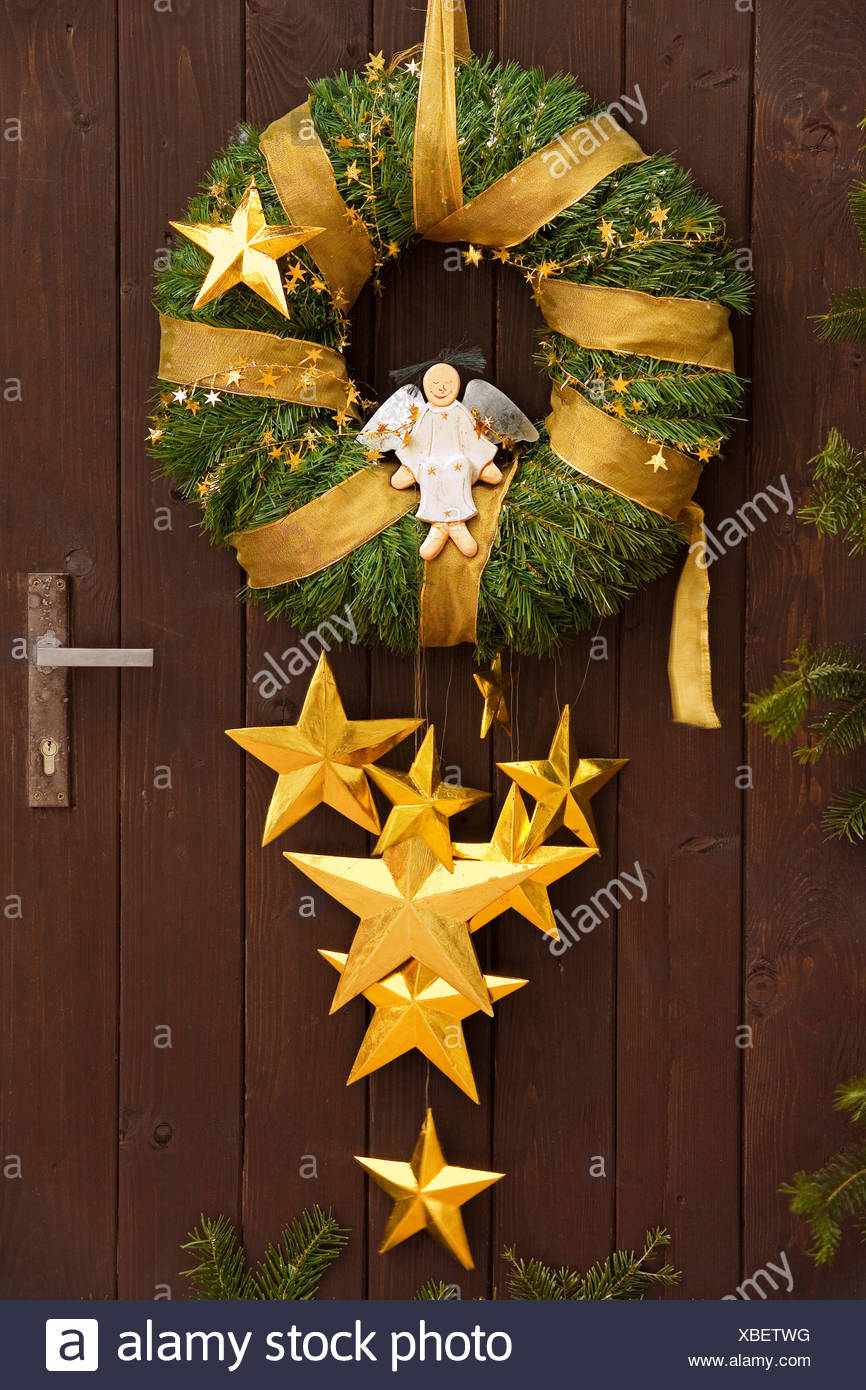 Christmas Wreath With Angel On A Wooden Door Stock Photo