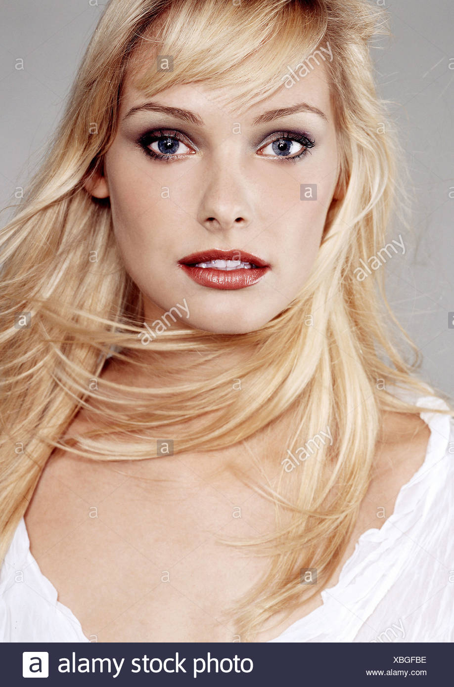 Female Long Blonde Hair Wearing Grey Eyeshadow And Mascara Orange