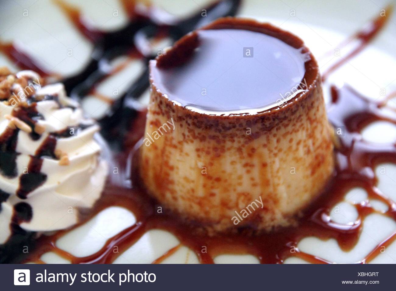 Flan caramel with cream on plate dessert Spain. Stock Photo