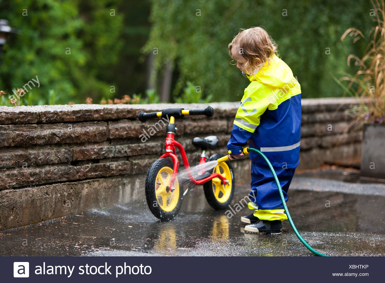 Boy washing bicycle Stock Photo 282519658 Alamy