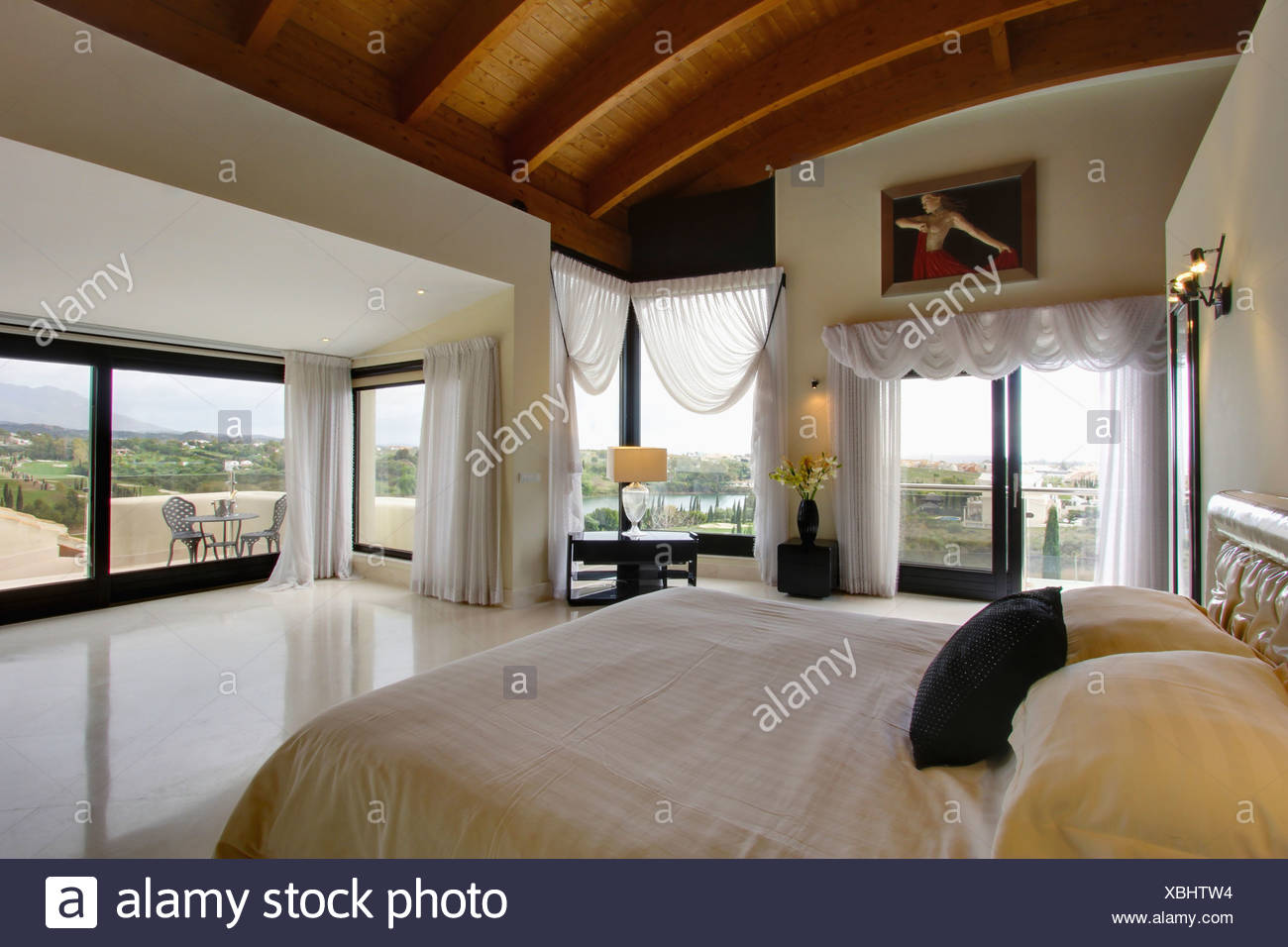 White Voile Drapes On Large Windows And Glass Doors In Modern