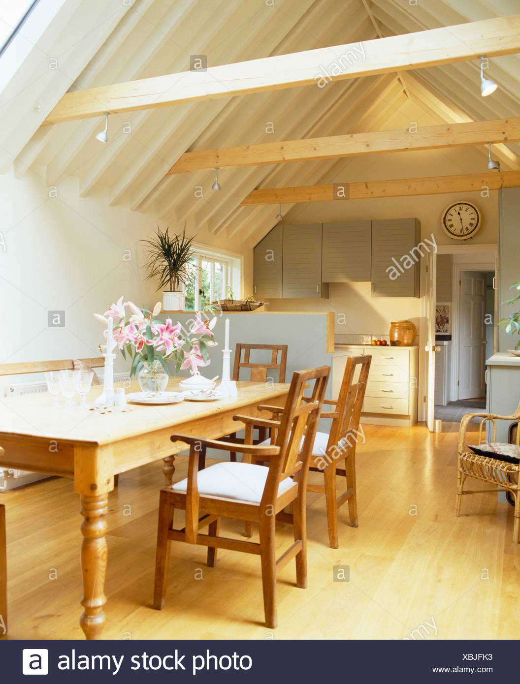 Wooden Chairs And Pine Table In Traditional Kitchen In Small Barn