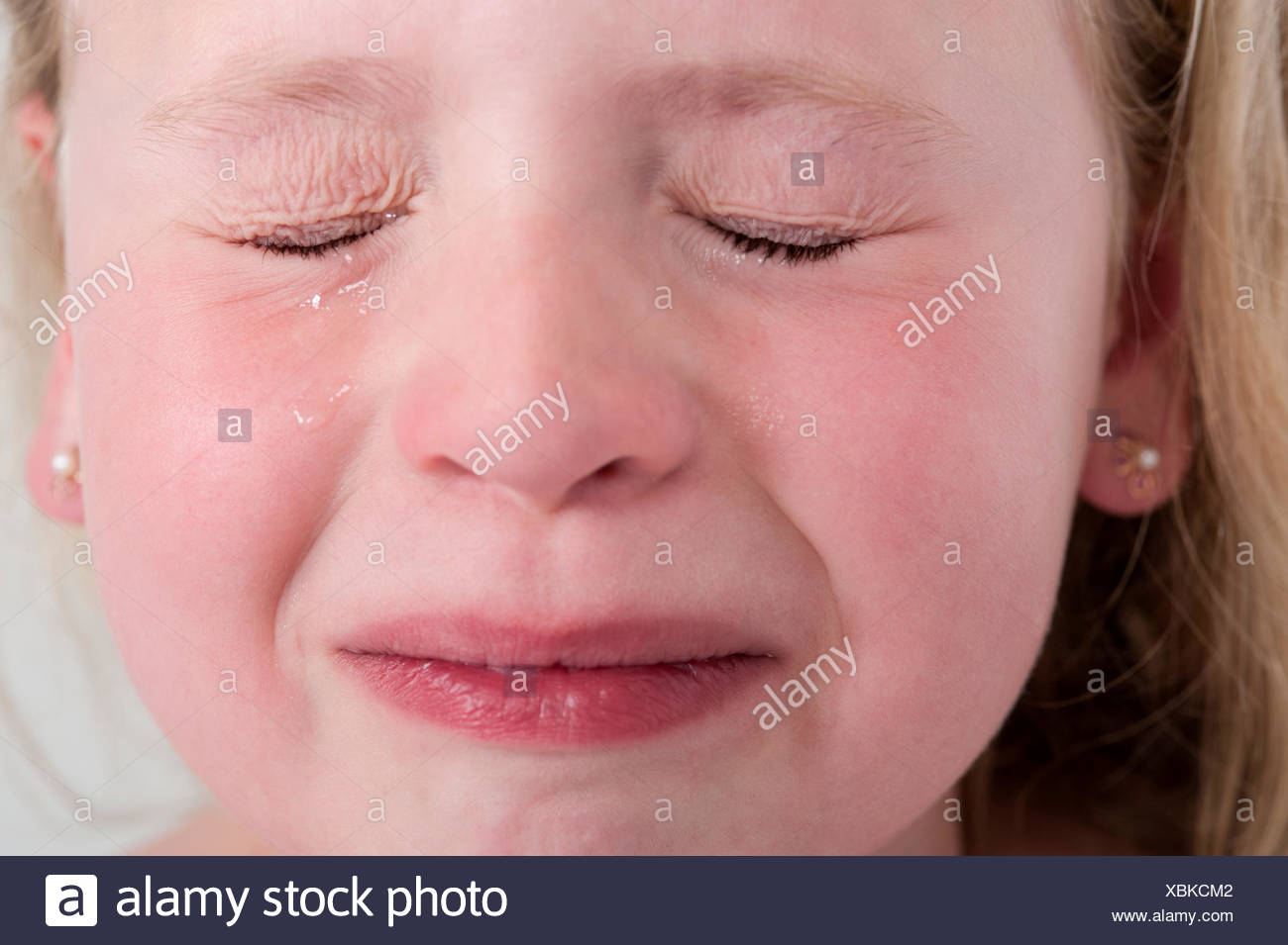 Model Released Girl With Eyes Closed Crying Stock Photo