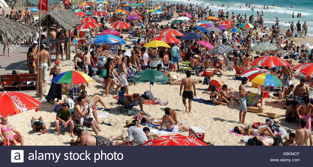 Summer vacation. holiday maker on a crowded beach. Photographed at Nitsanim Beach, Israel Stock Photo
