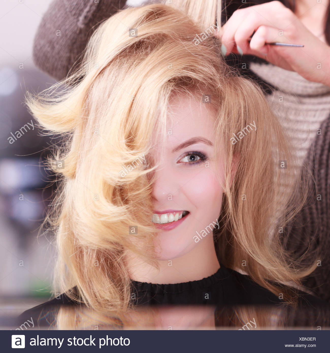 Beautiful Smiling Girl With Blond Wavy Hair By Hairdresser