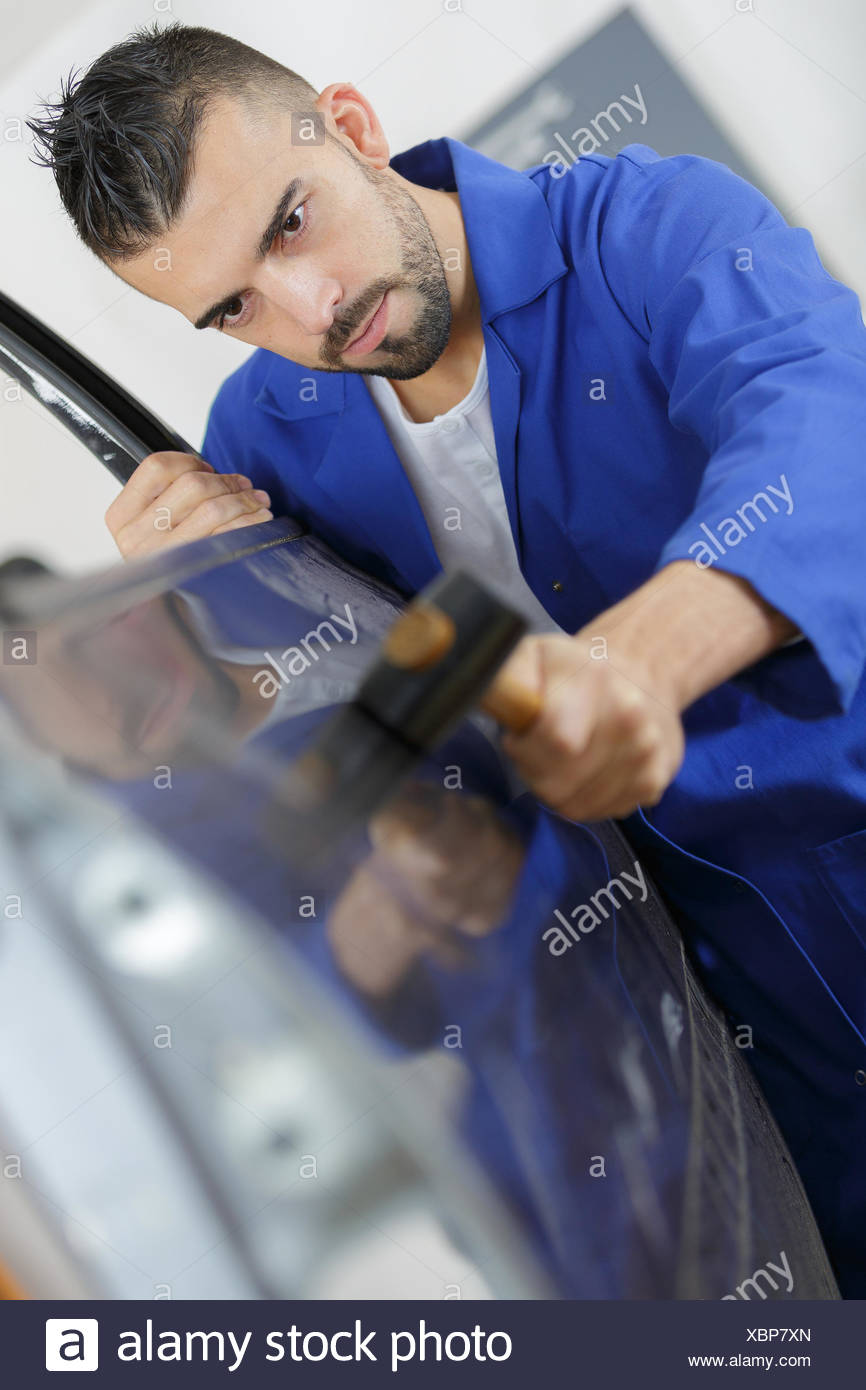 Mechanic Fixing A Car Door With A Hammer Stock Photo 282616285