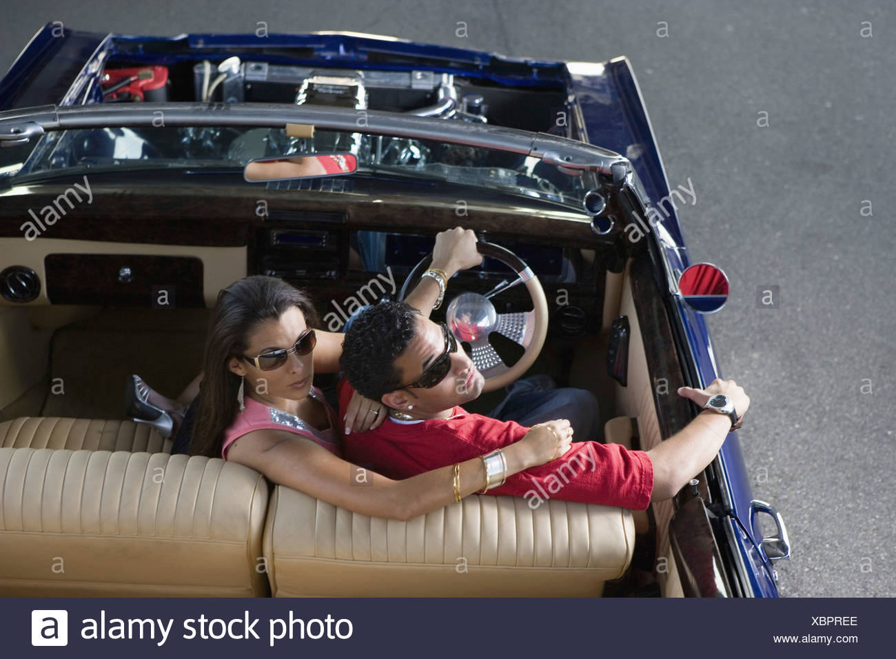 Portrait Of A Young Hip Hop Couple Sitting In A Pimped Up Vintage Car Stock Photo Alamy