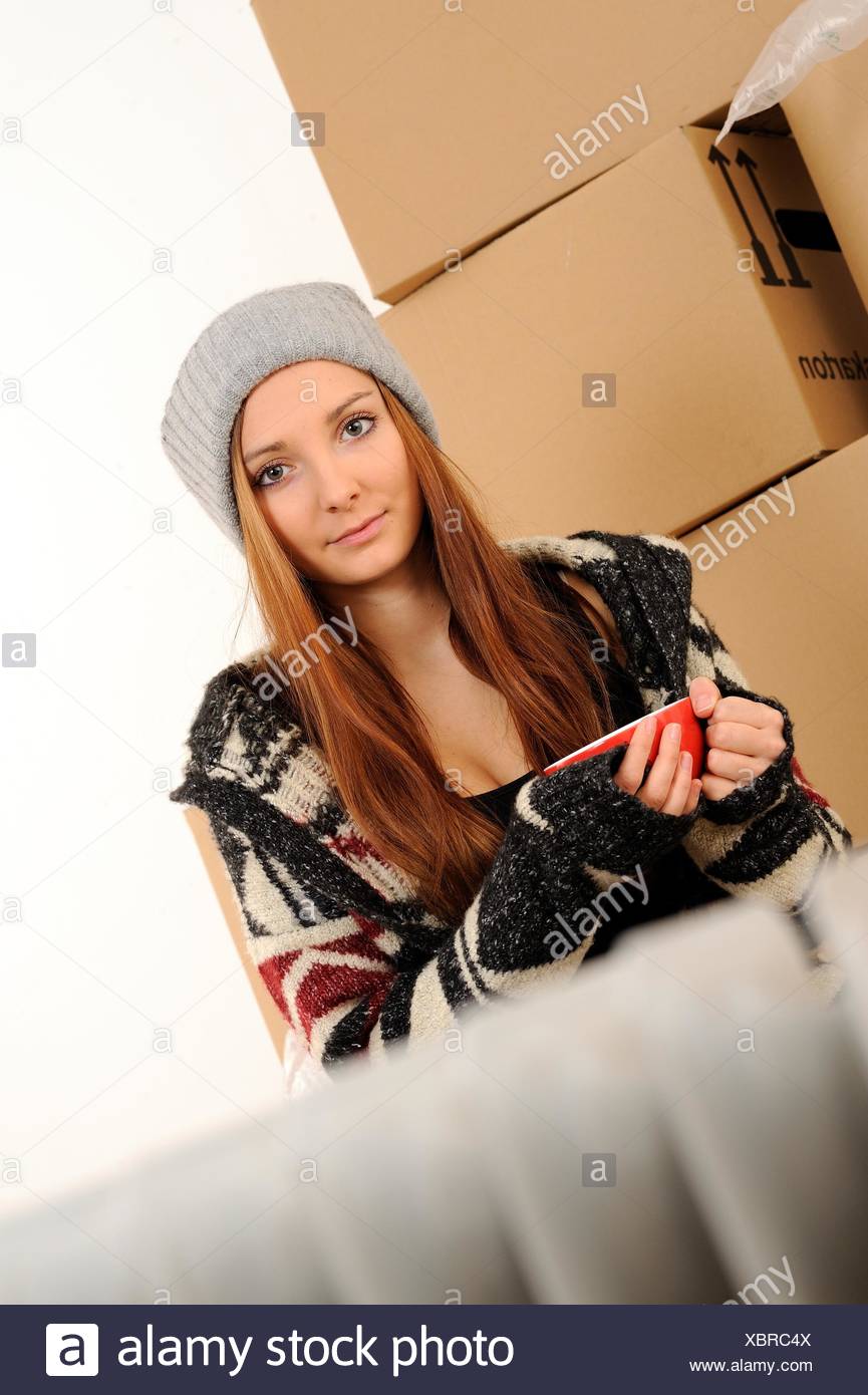 Young woman with packing cases Stock Photo
