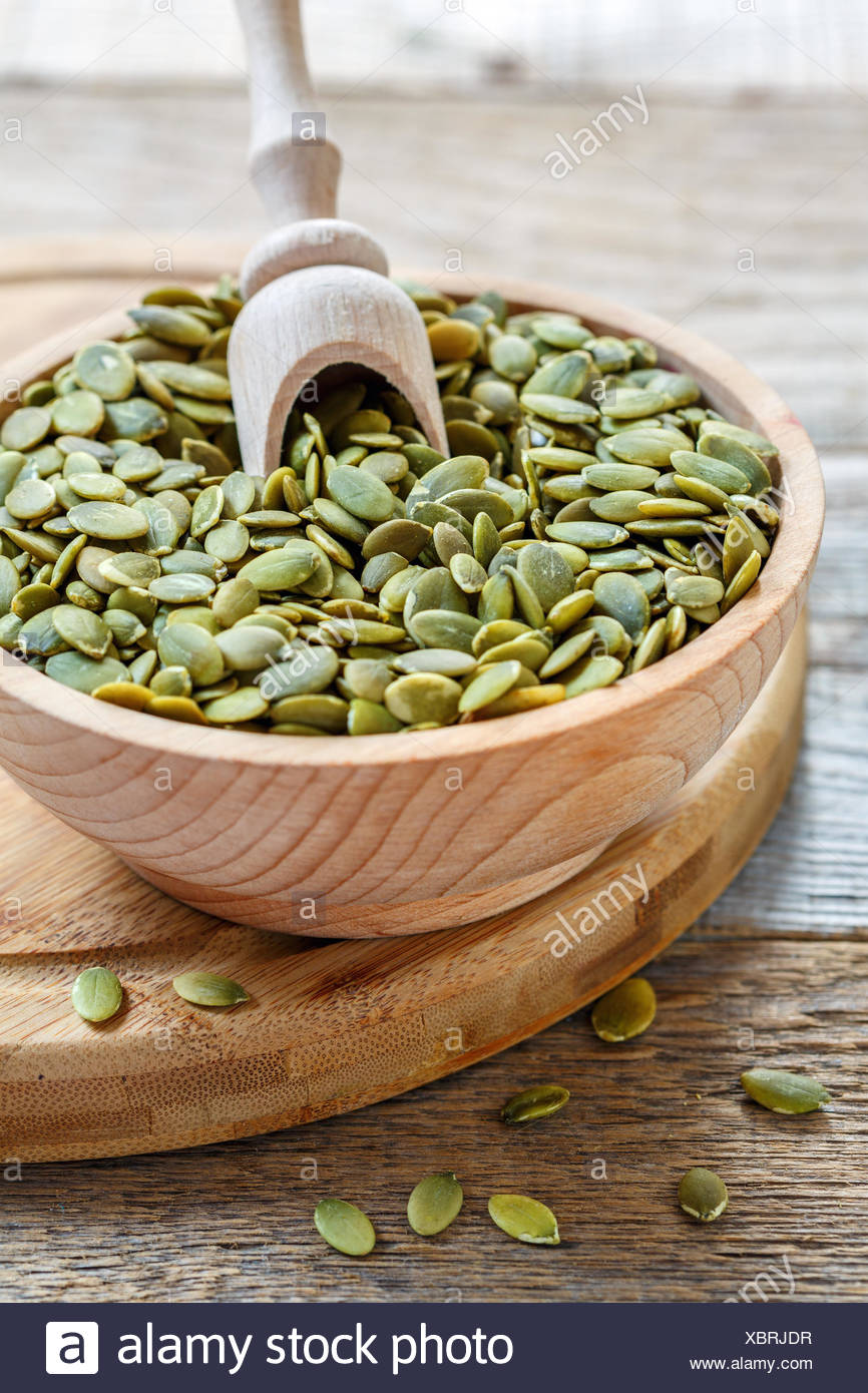 Download Peeled Pumpkin Seeds In A Wooden Bowl Stock Photo Alamy Yellowimages Mockups