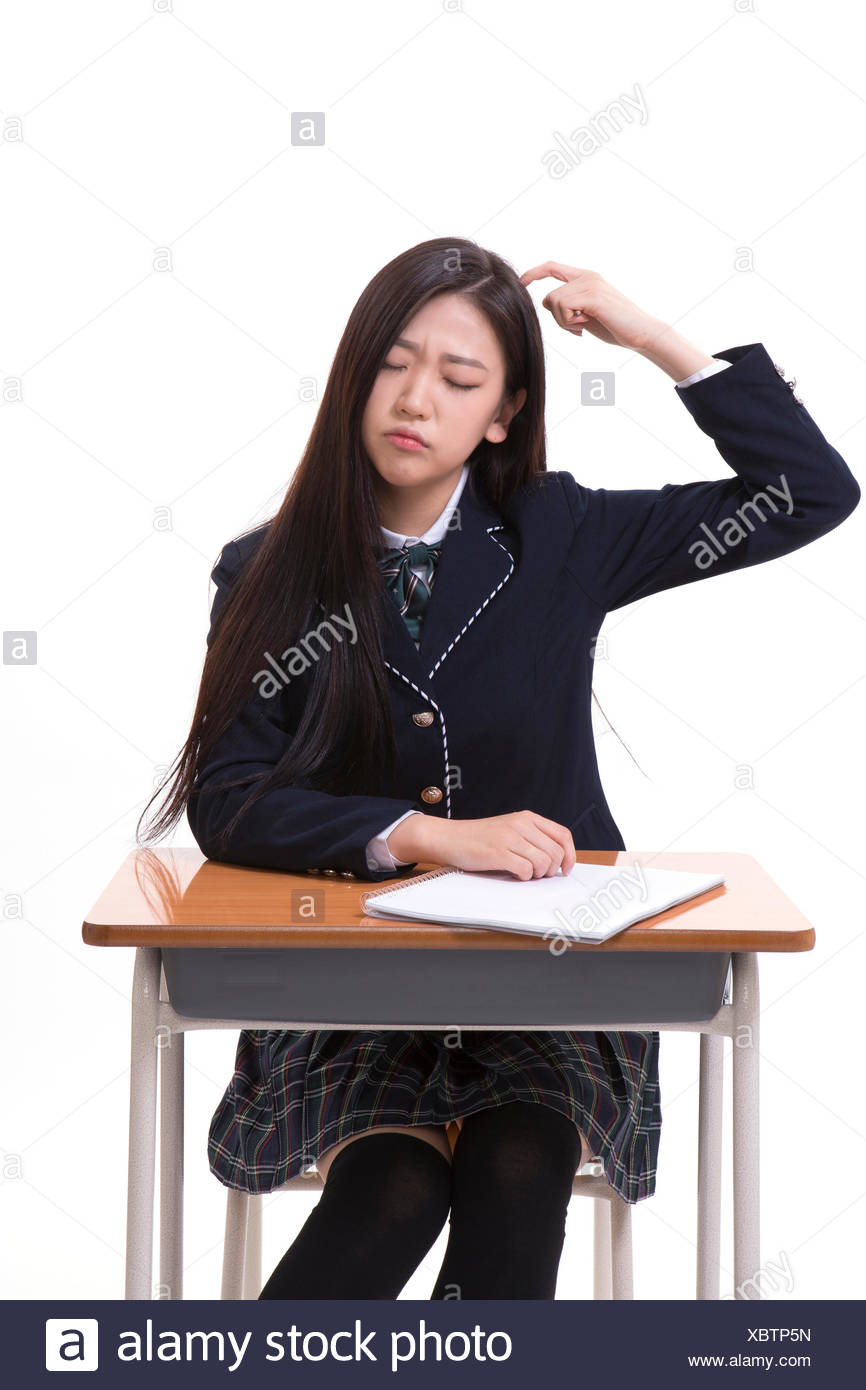 Stressful Korean High School Girl Sitting At Desk Stock Photo