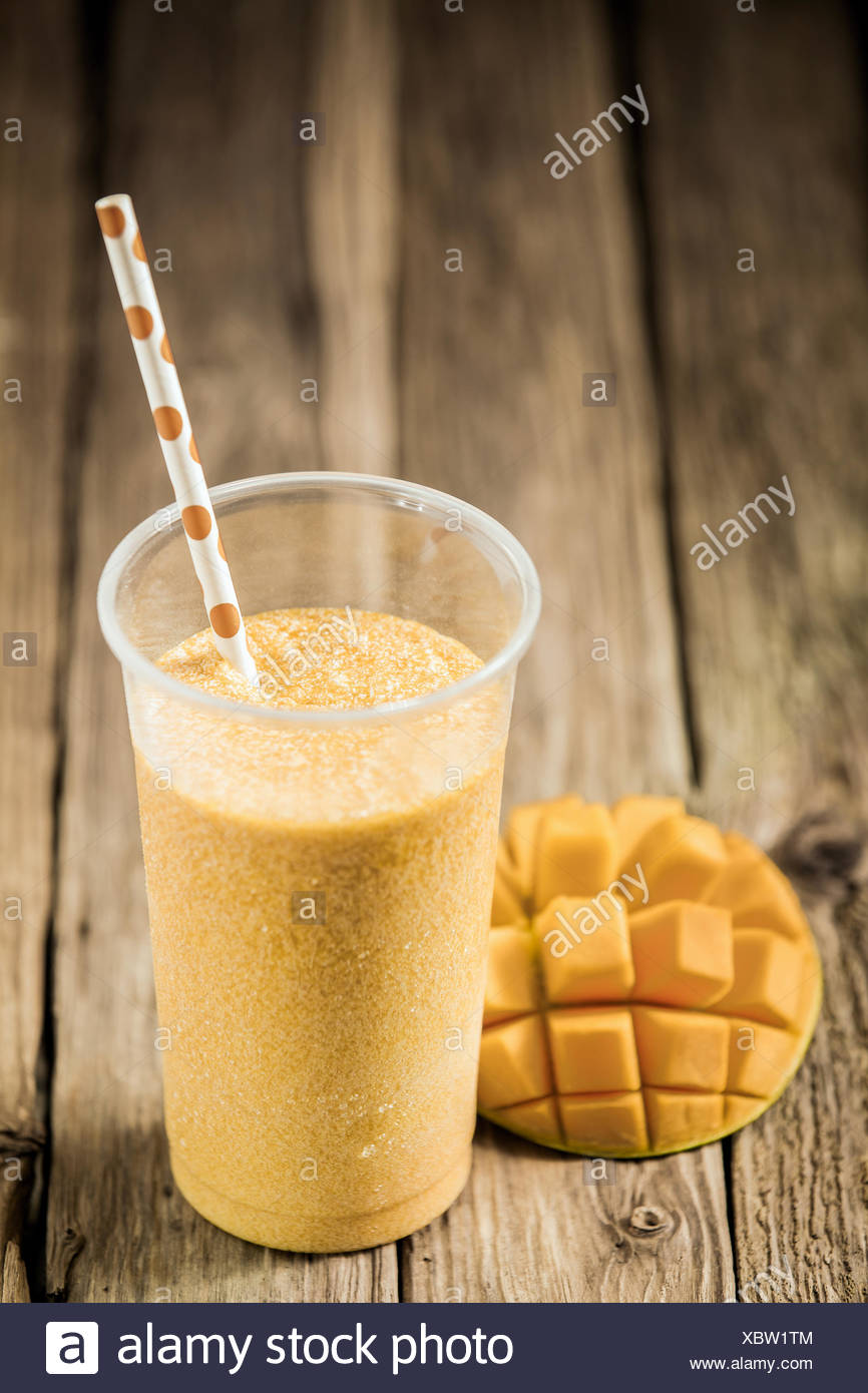 High Angle View Of A Glass Of Tropical Mango Smoothie Blended With Yogurt And Ice Cream With Fresh Fruit On An Old Weathered Wooden Table With Copyspace Stock Photo Alamy