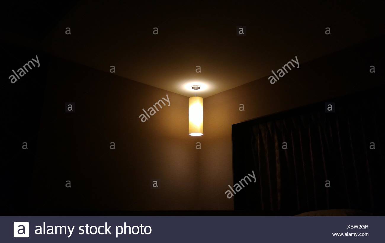 Illuminated Light Fixture In Corner Of Room Stock Photo