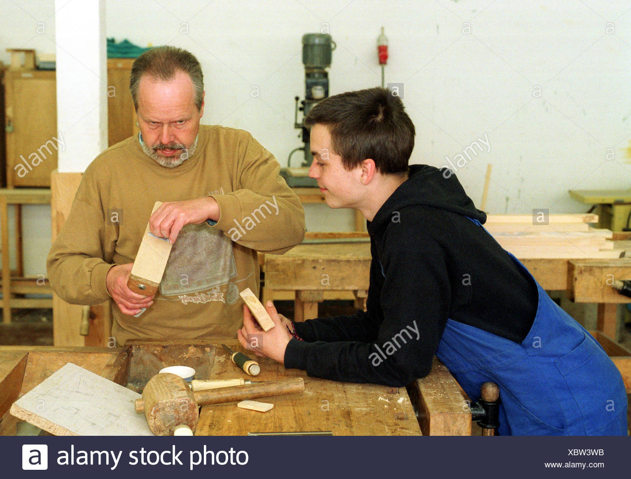 Berlin A Carpenter Apprentice Is Instructed By His Master Stock Photo Alamy