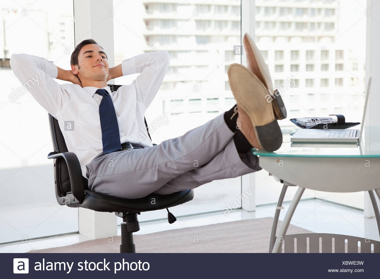 happy-businessman-feet-on-his-desk-XBWE3W.jpg