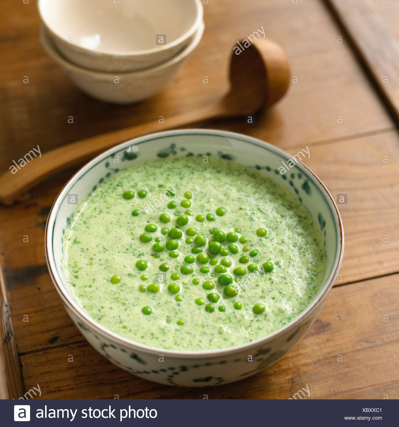 Chilled lettuce soup in a bowl with peas on top Stock Photo