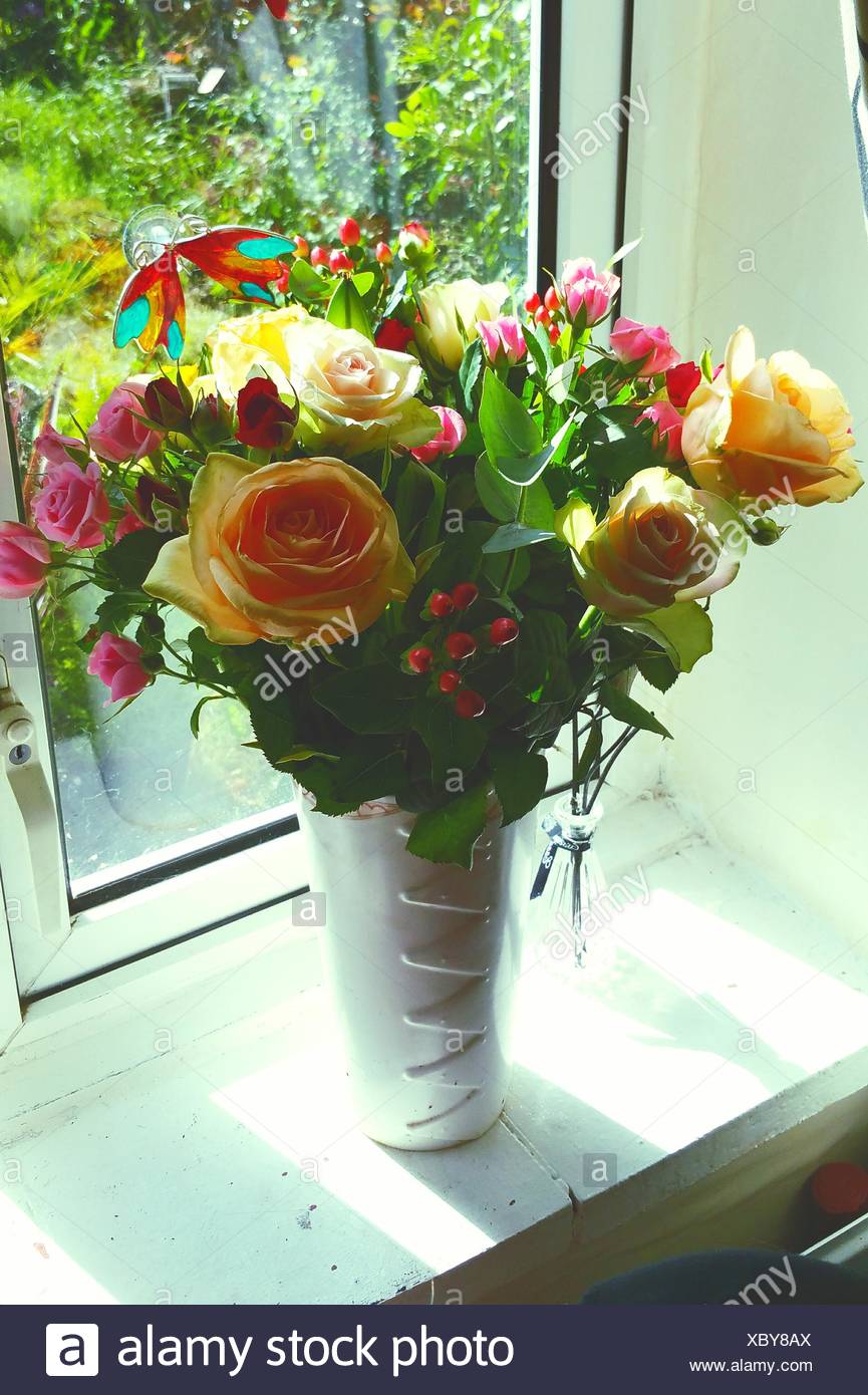 Flowers In Vase On Window Sill High Resolution Stock Photography and