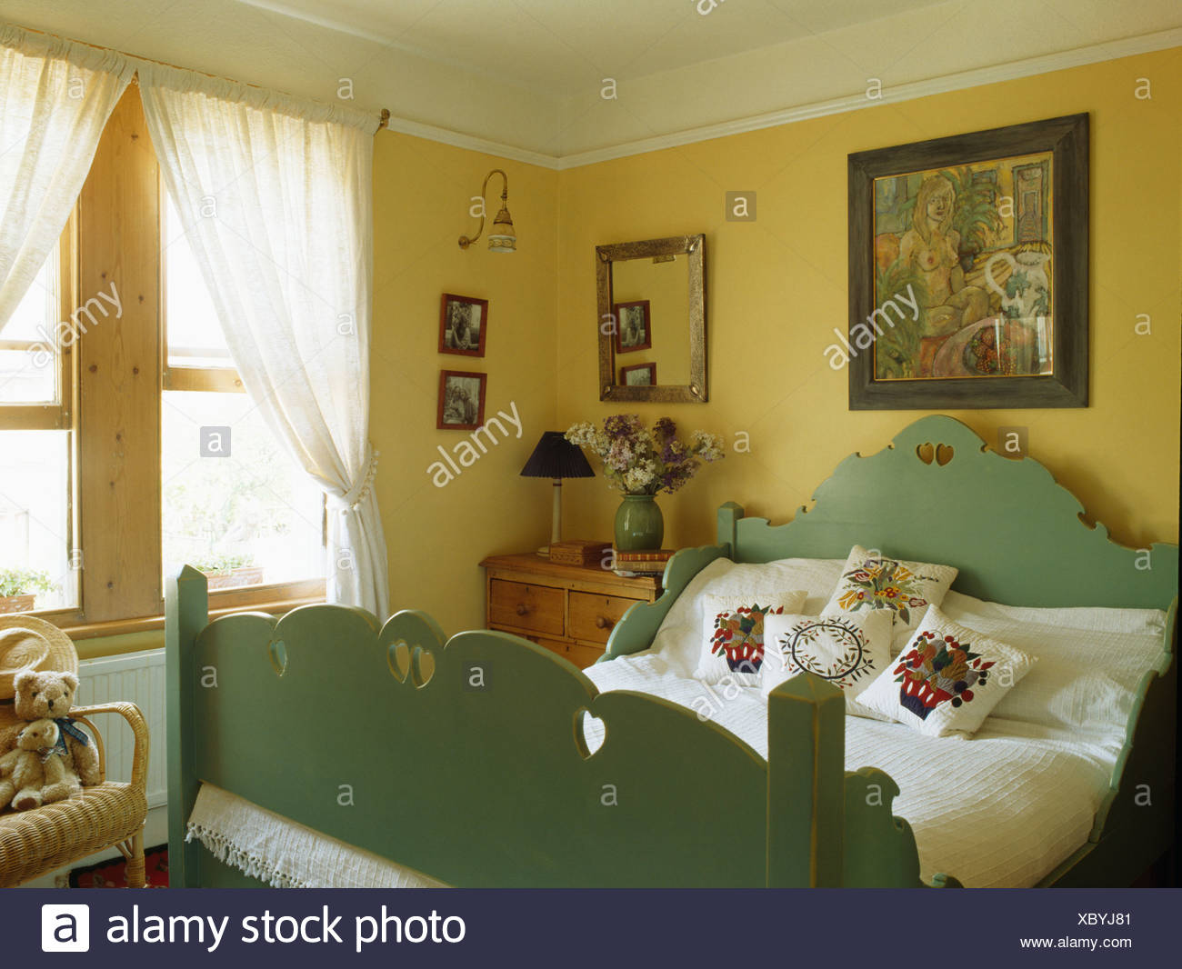 Picture On Wall Above Green Painted Wooden Bed With