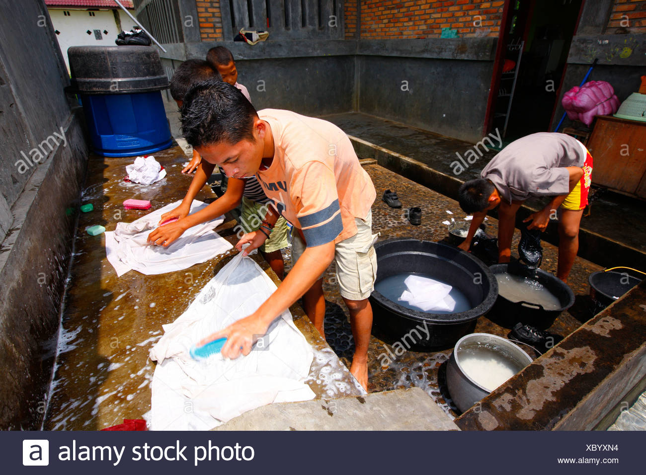 Children washing school uniforms, Margaritha children's home, Marihat, Batak region, Sumatra island, Indonesia, Asia Stock Photo