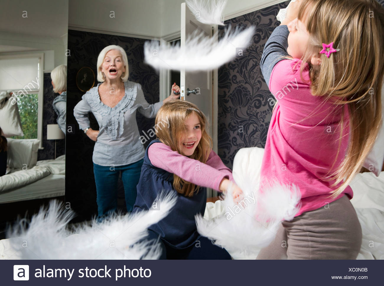 A Granny Shouts At Girls Pillow Fighting Stock Photo 282758235