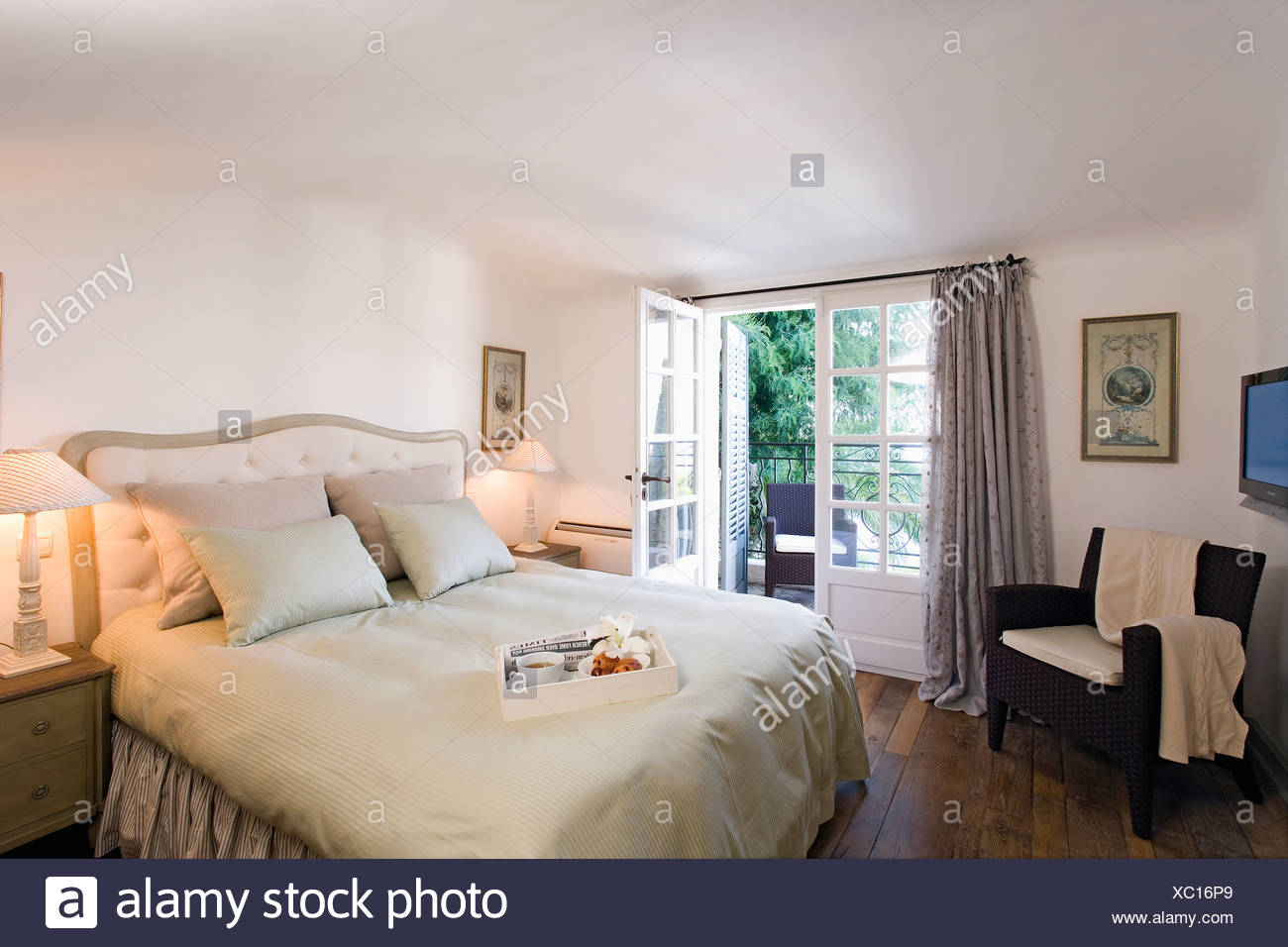 Bedroom With Grey Silk Quilt And Cushions On Bed And Brown