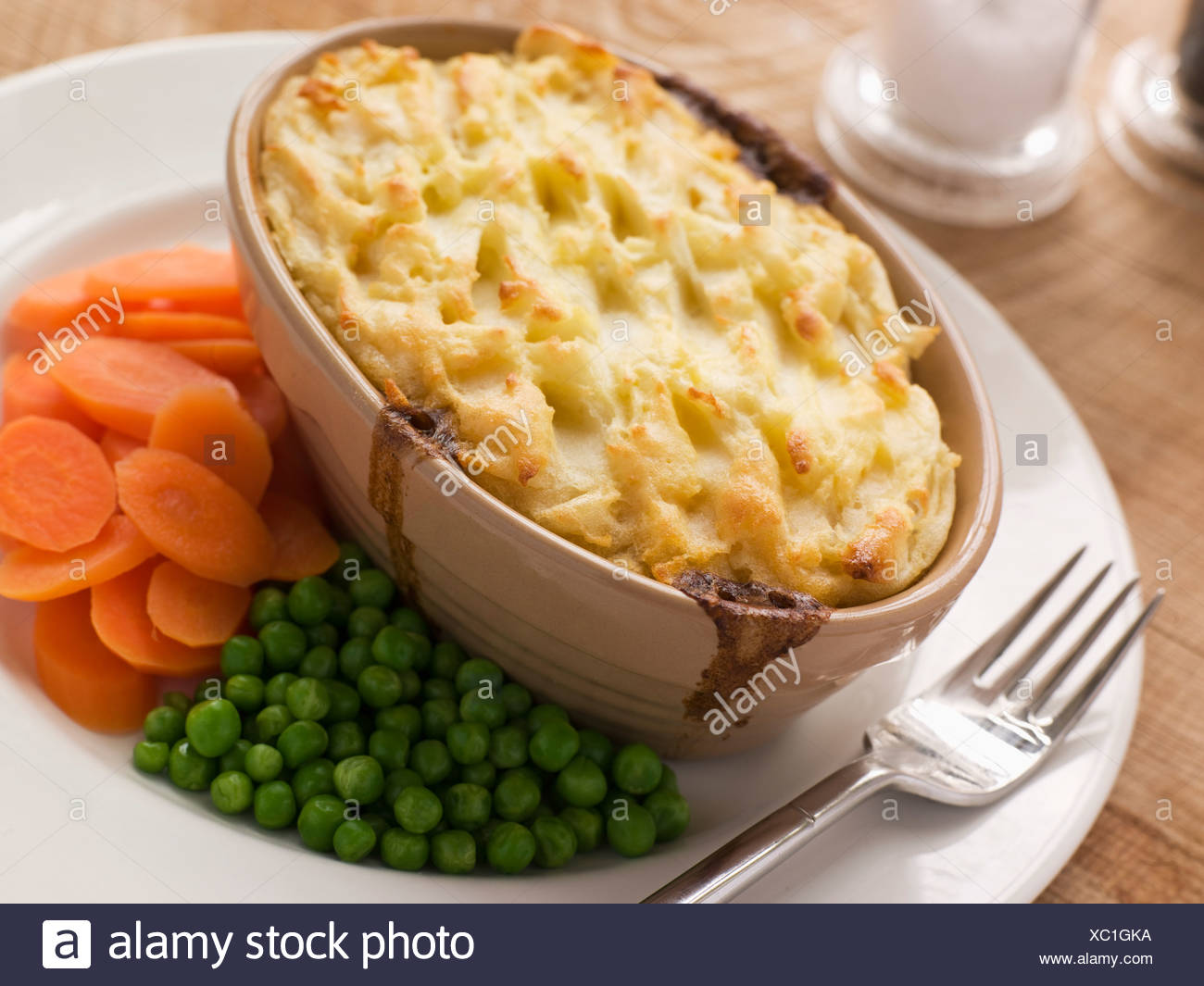 Individual Cottage Pie With Peas And Carrots Stock Photo