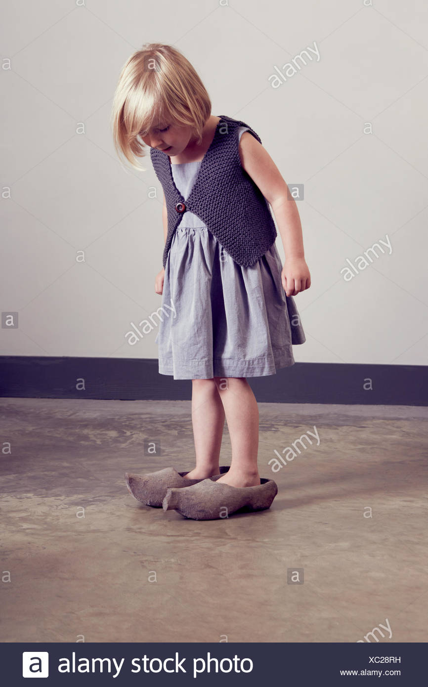 Girl standing in vintage wooden clogs 