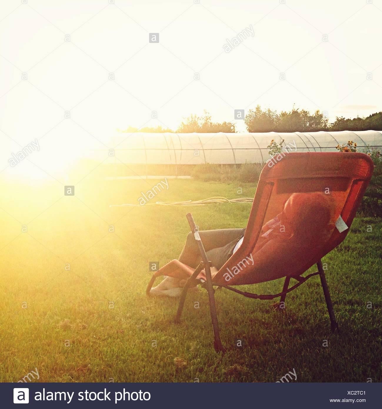 Woman Sleeping In Lounge Chair High Resolution Stock Photography and