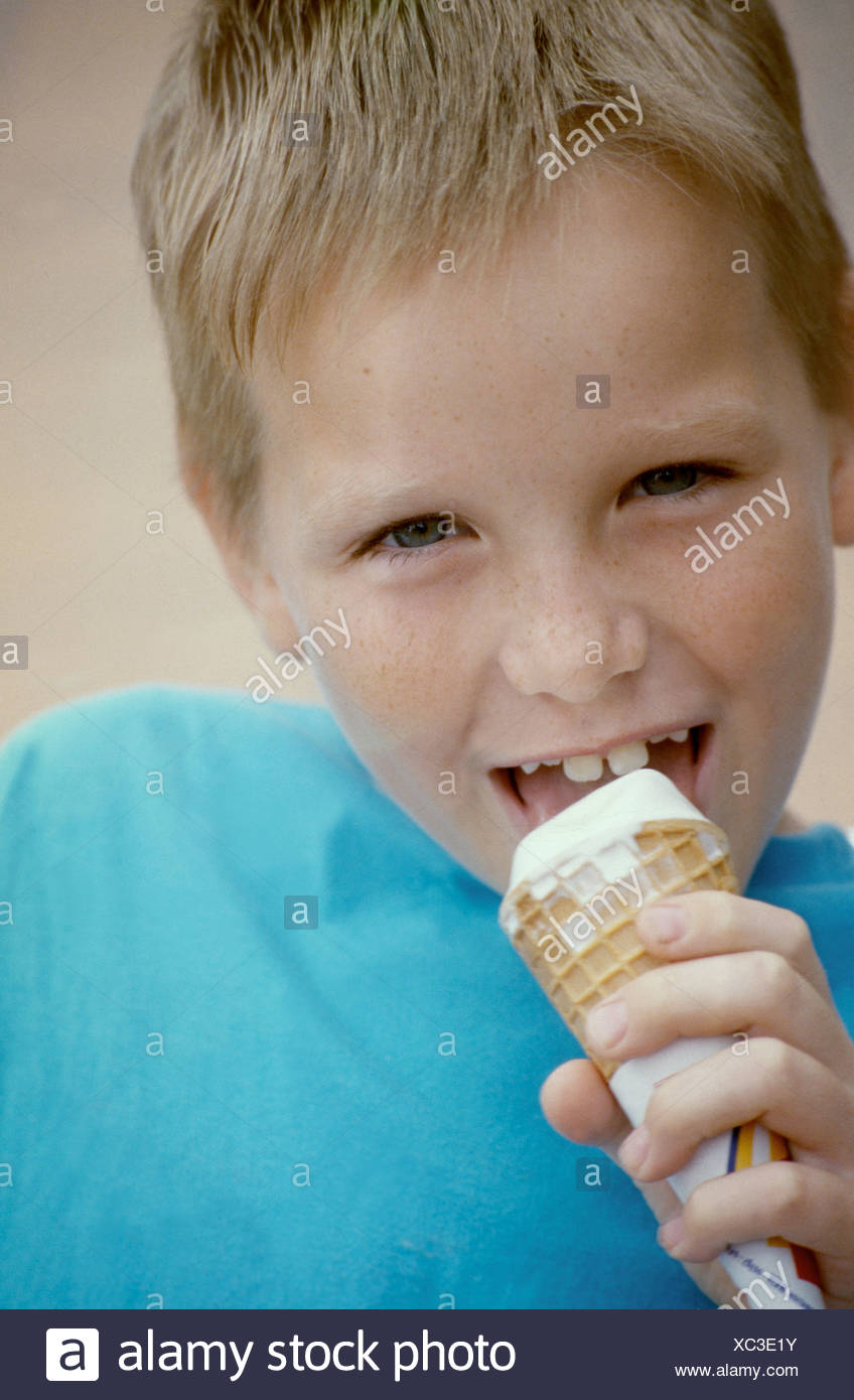 Mclose Up Of Male Child Blonde Hair Wearing Blue T Shirt Eating