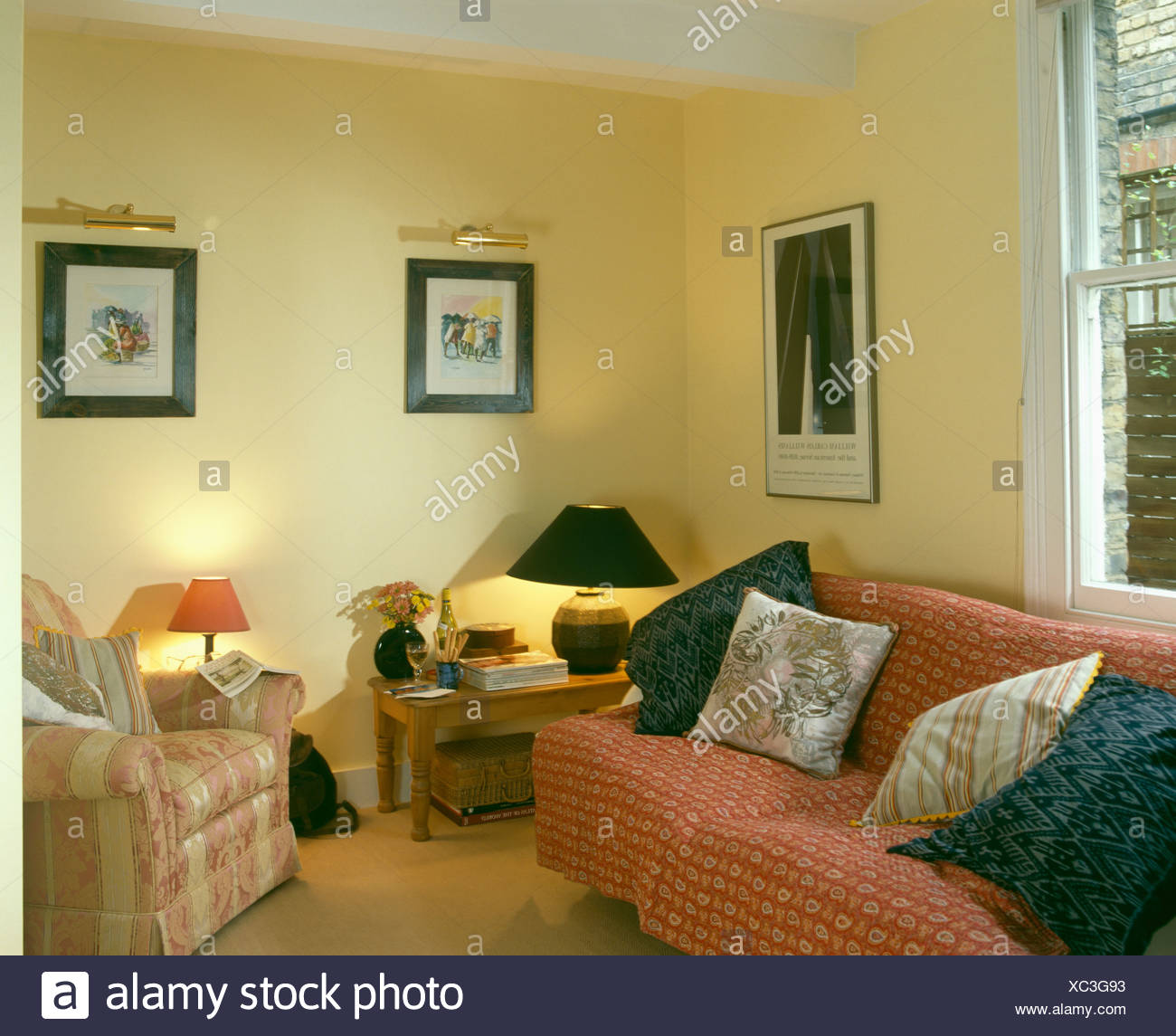 Cushions On Patterned Red Throw On Sofa In Pale Yellow Nineties