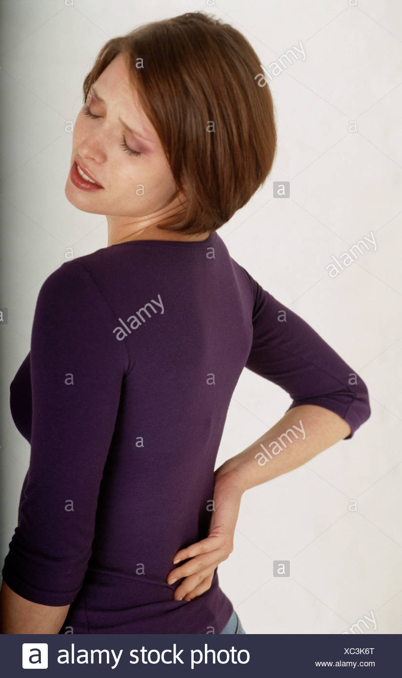 Female With Short Brunette Hair Wearing Purple Top Suffering