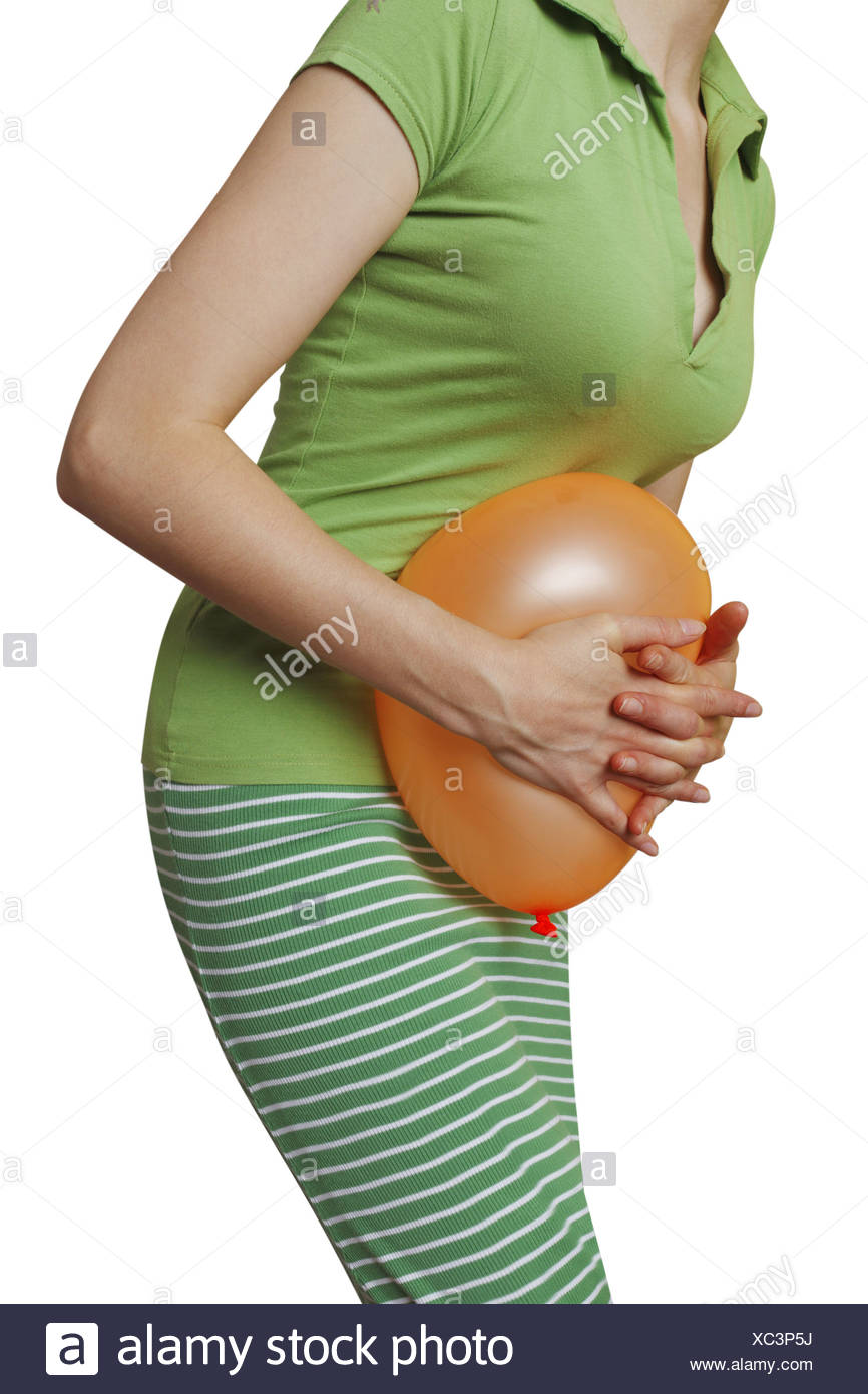 Woman pushing a balloon against her belly, symbolic image for ... Woman pushing a balloon against her belly, symbolic image for ...