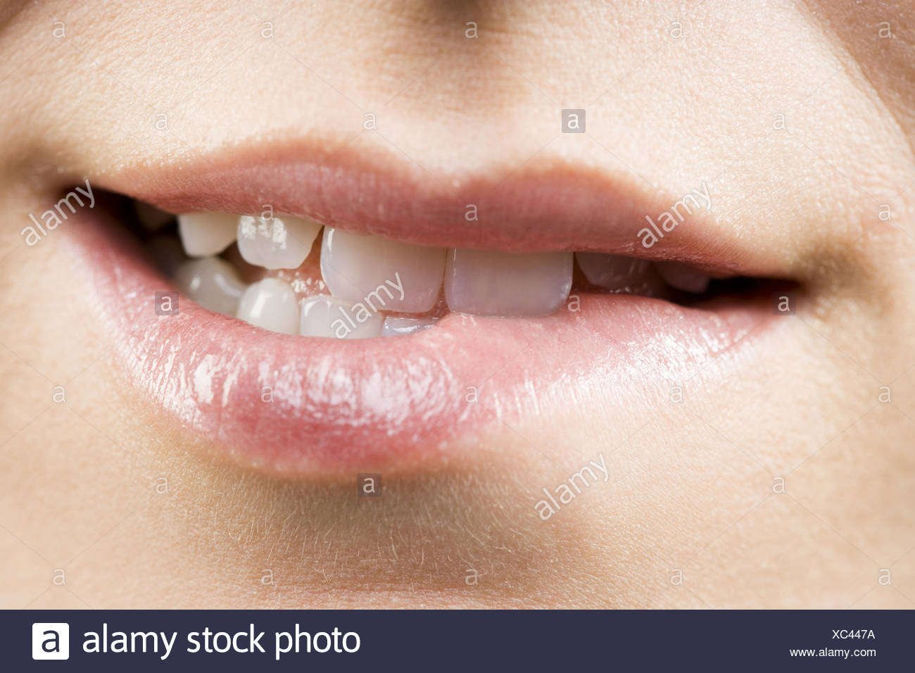 close-up-of-a-woman-biting-her-lower-lip-XC447A.jpg