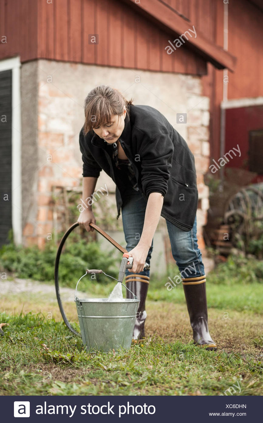 Woman Fill Buckets High Resolution Stock Photography and Images Alamy