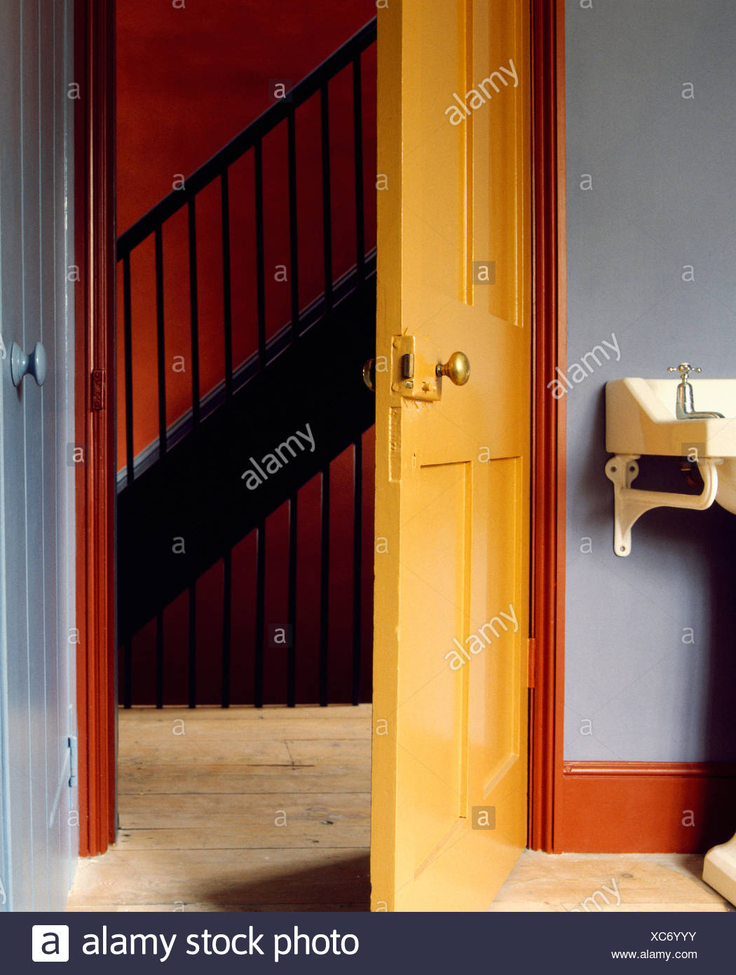Download Open Yellow Wooden Door In Bathroom With Red Woodwork And Grey Walls Stock Photo Alamy PSD Mockup Templates