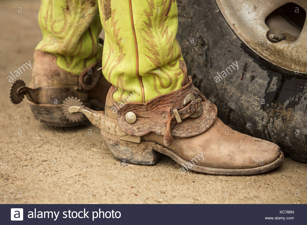 USA, Texas, Cowboy boots with spurs next to pickup truck ...