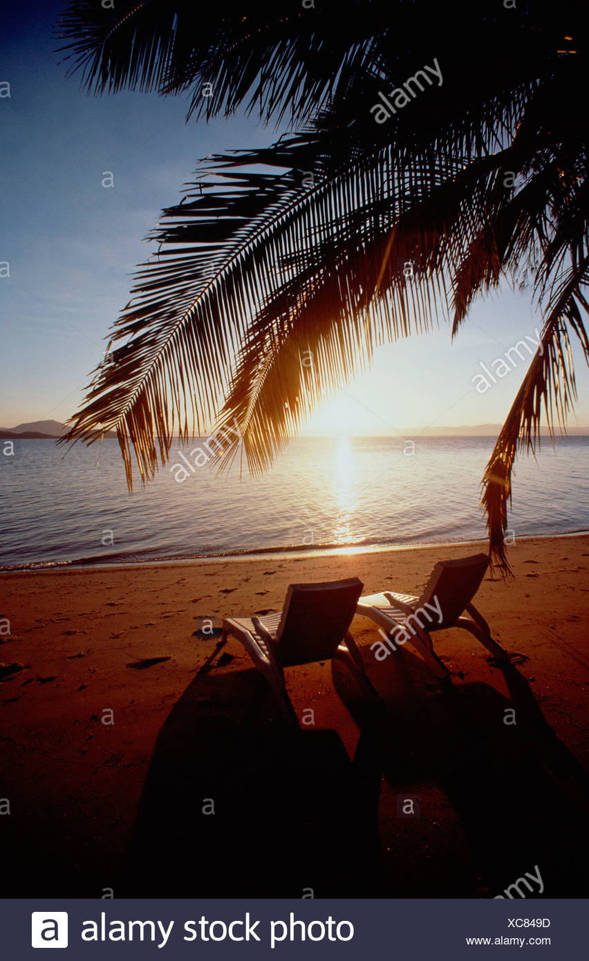 Two Empty Beach Lounger Chairs On Deserted Tropical Beach At Sunset Queensland Australia Bedarra Island Stock Photo Alamy