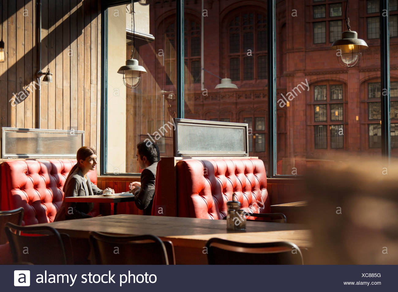 Couple Sitting In Restaurant Booth High Resolution Stock Photography