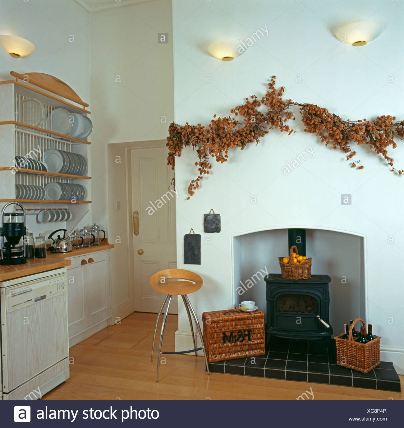 Dried Flower Garland Above Simple Fireplace With Wood Burning