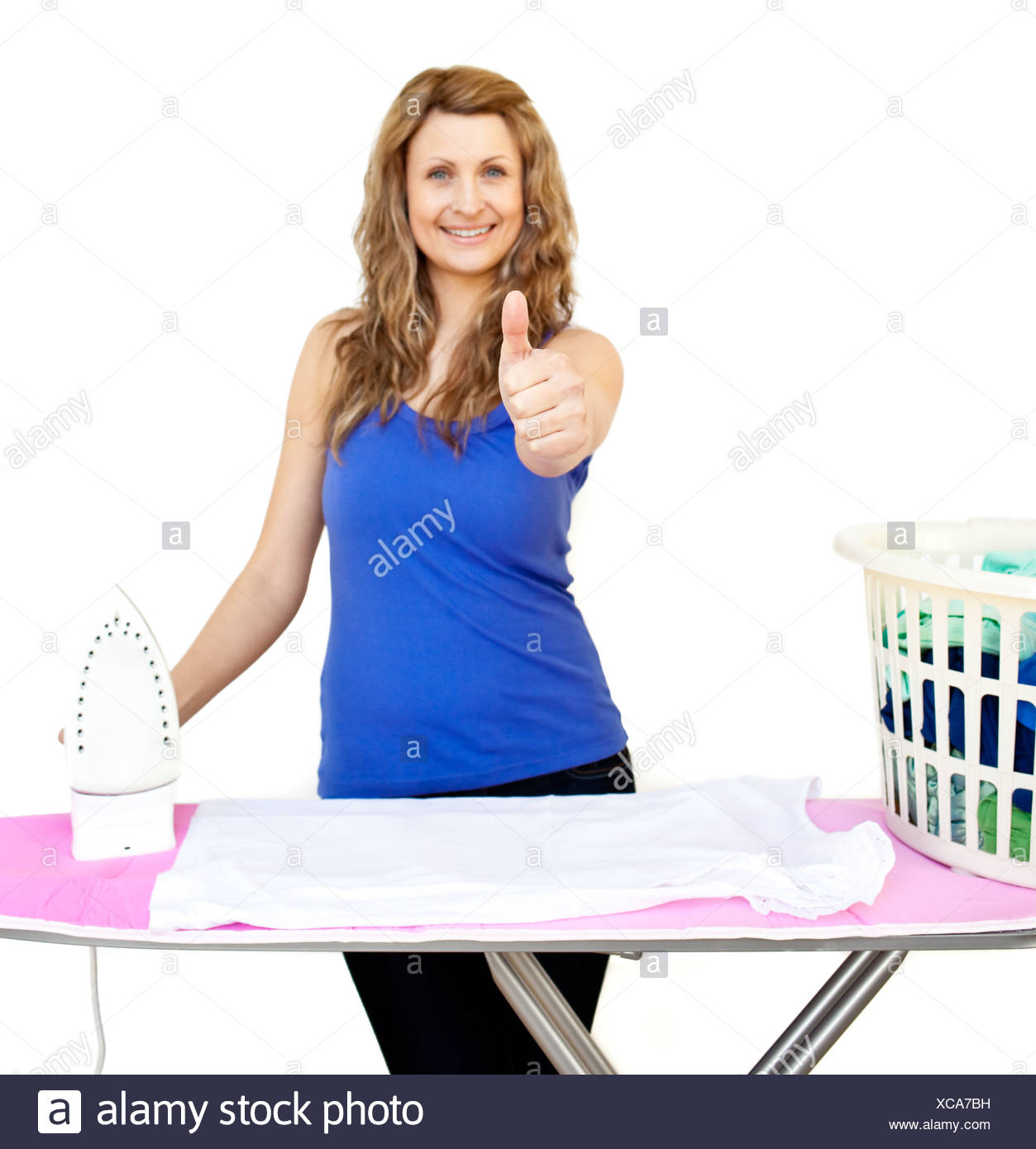 Handsome Woman Standing Behind An Ironing Board With Thumbs Up