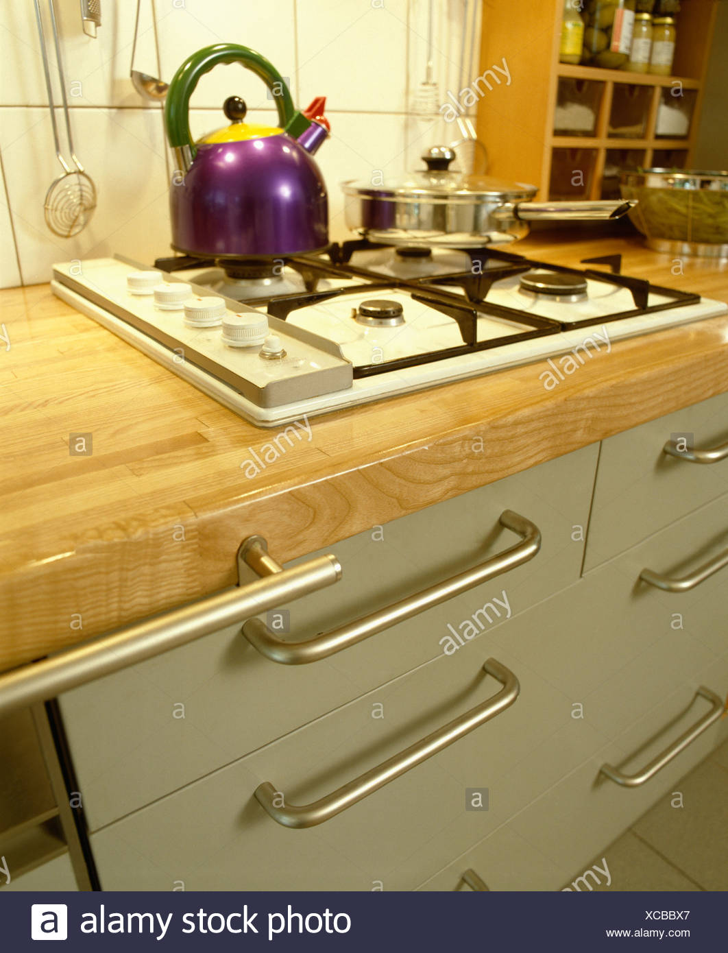 Close Up Of Purple Alessi Kettle On White Gas Hob In Kitchen