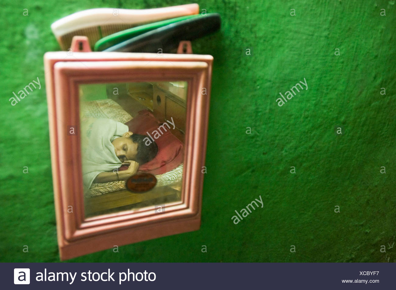 Khusbun Nessa, tuberculosis patient lying sick in her bed at home while her family cares for her, Howrah, Hooghly, West Bengal, Stock Photo