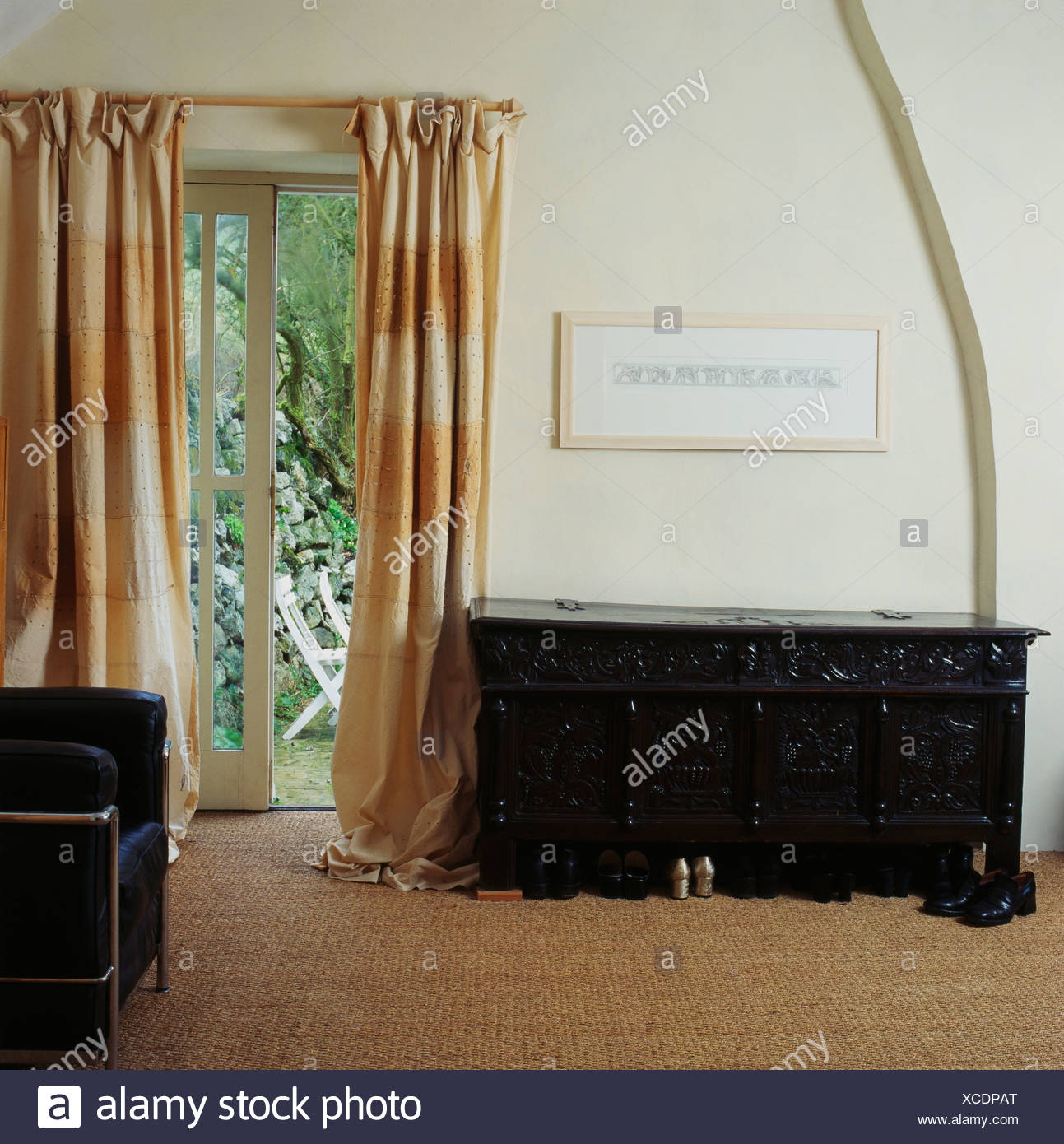 Carved Wooden Antique Chest Beside French Windows With Cream Large